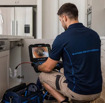 Clearing a blocked sink at a Carramar property
